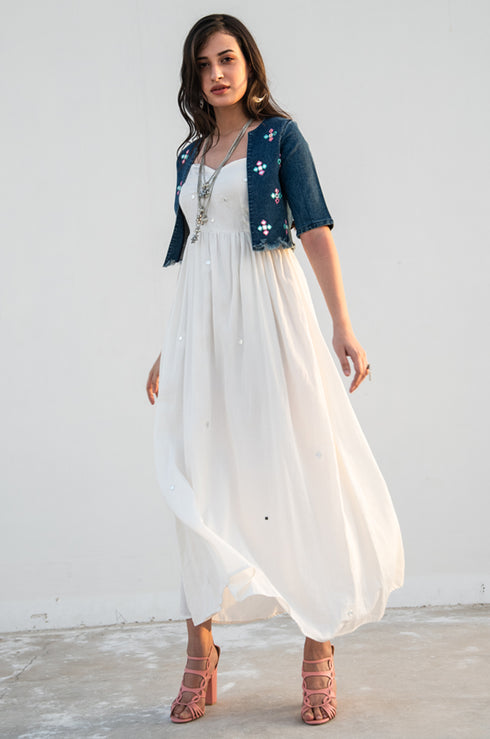 Model posing and looking into the camera, dressed in our white ‘Tannon Long Dress’.